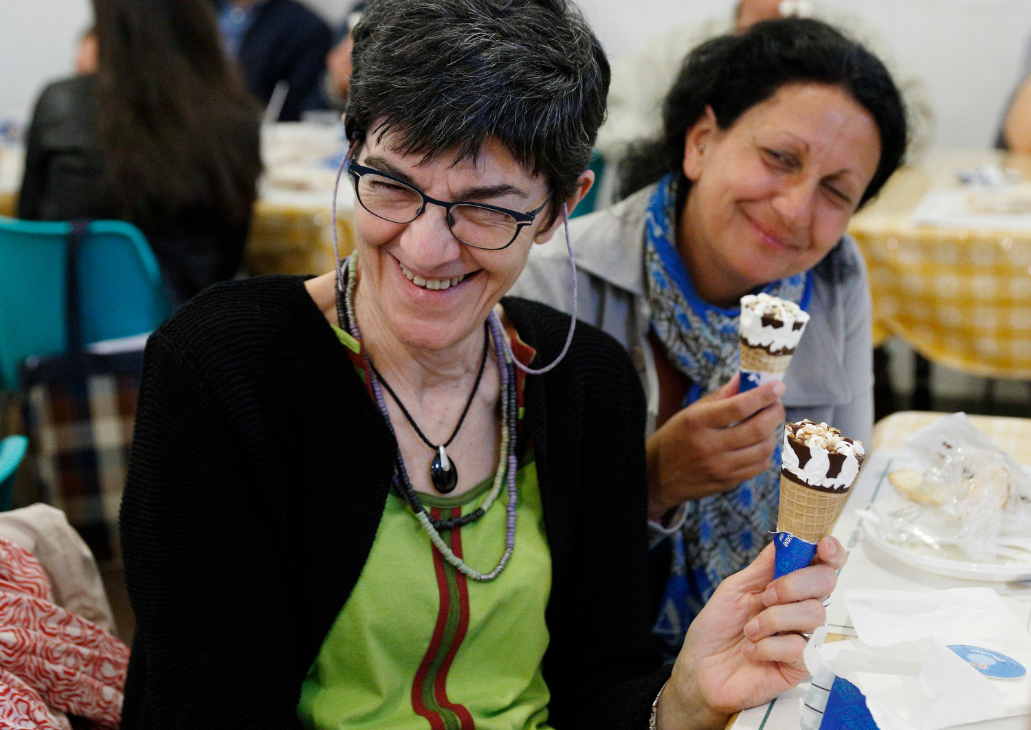 People eat ice cream cones donated by Pope Francis at a Sant’Egidio soup kitchen in Rome April 23. In honor of his name day, the feast of St. George, the Pope donated 3,000 servings of ice cream to soup kitchens and homeless shelters around Rome.